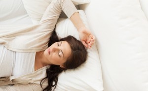 pregnancy, rest, people and expectation concept - happy pregnant woman sleeping in bed at home